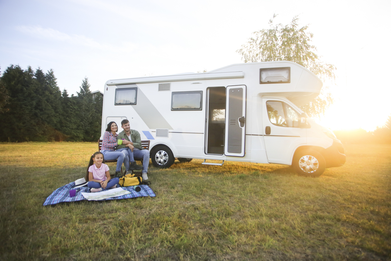 Class C motorhomes - Family camping in a recreational vehicle. About 30 years old parents and a 8 years old daughter, all Caucasian people.