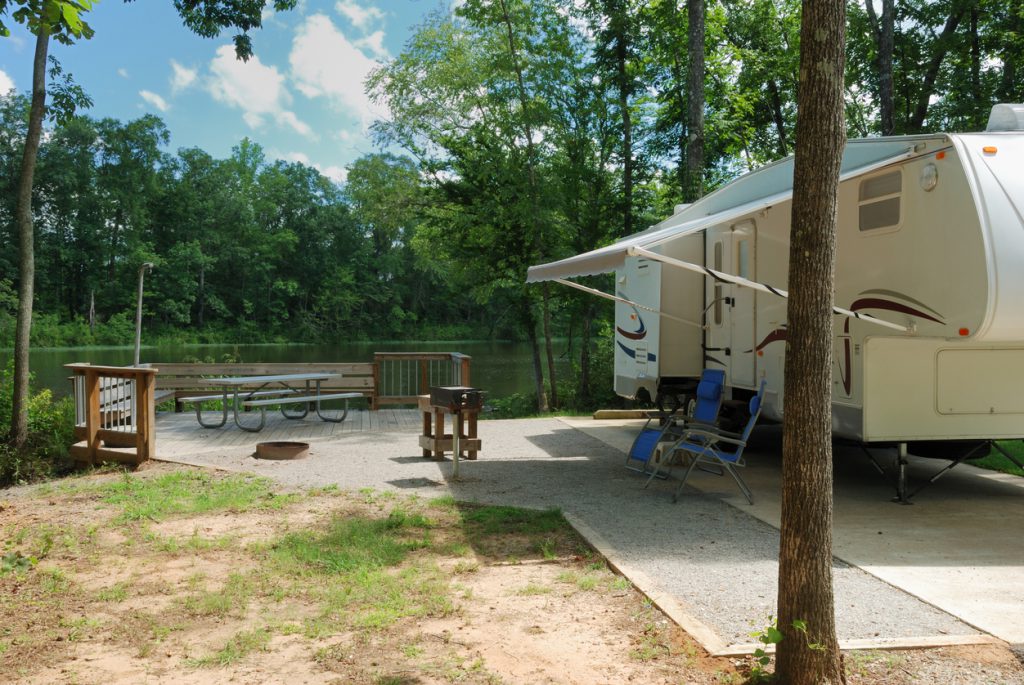 tow a fifth wheel - RV trailer at riverside campsite