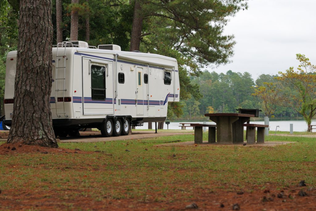 tow a fifth wheel - Fifth wheel camper in campground by lake